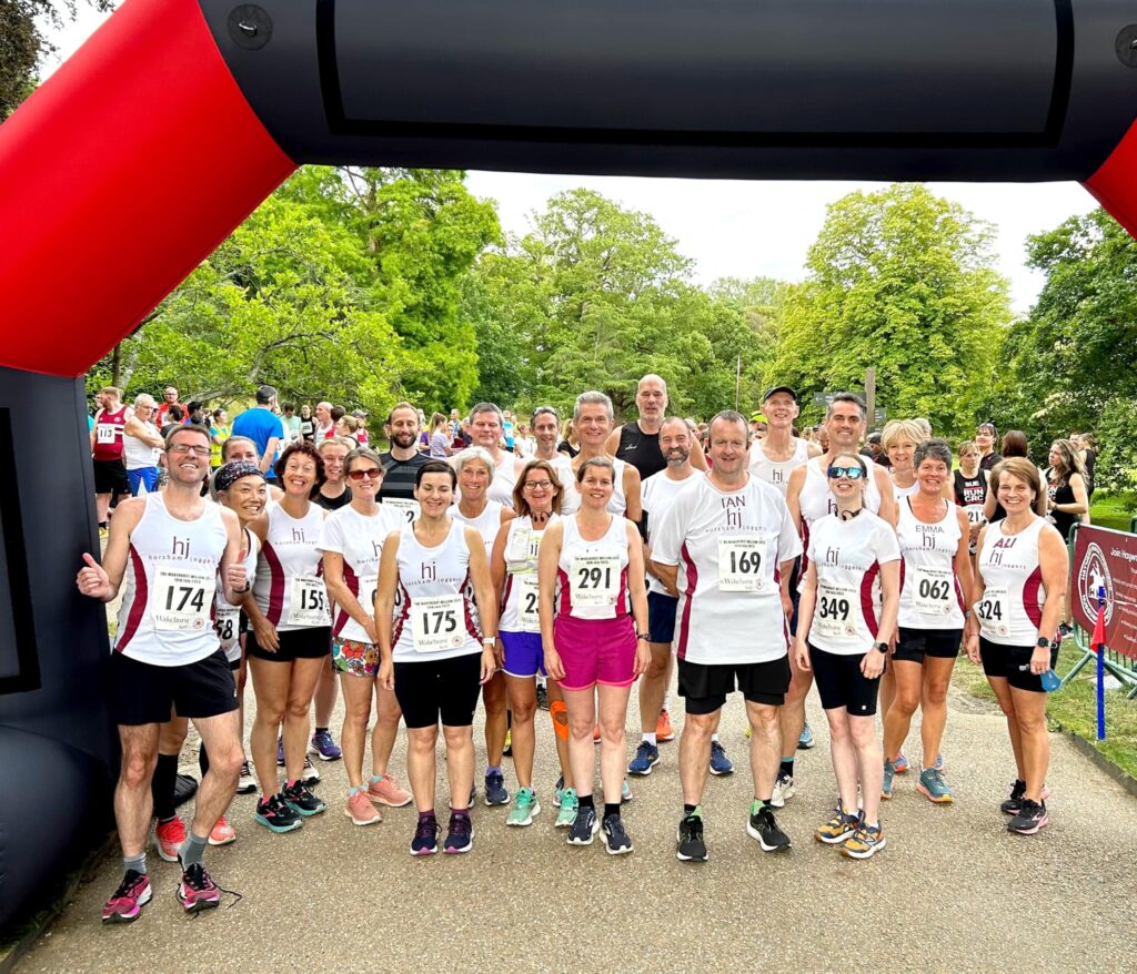 A group of runners under an inflatable arch