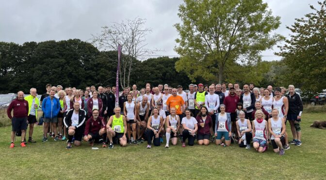 A large group of runners on a green field