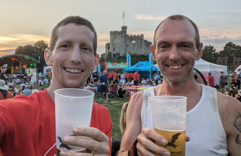 Gary Tomlinson and Michael Dargue holding a well earned beer after the event