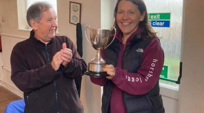 Julie Jochimsen holds aloft the trophy