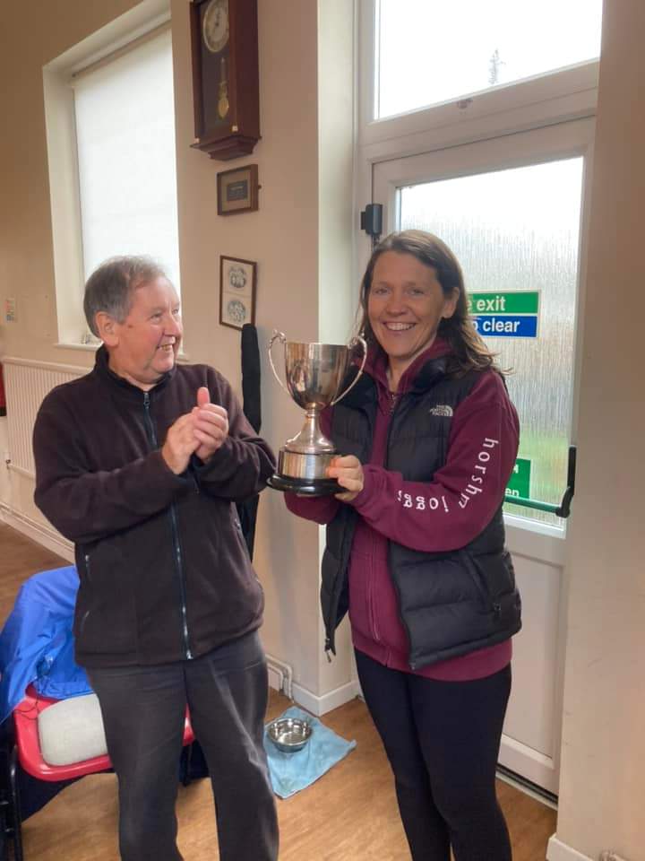 Julie Jochimsen holds aloft the trophy