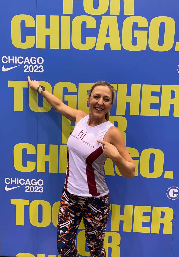 A runner in front of Chicago Marathon banner