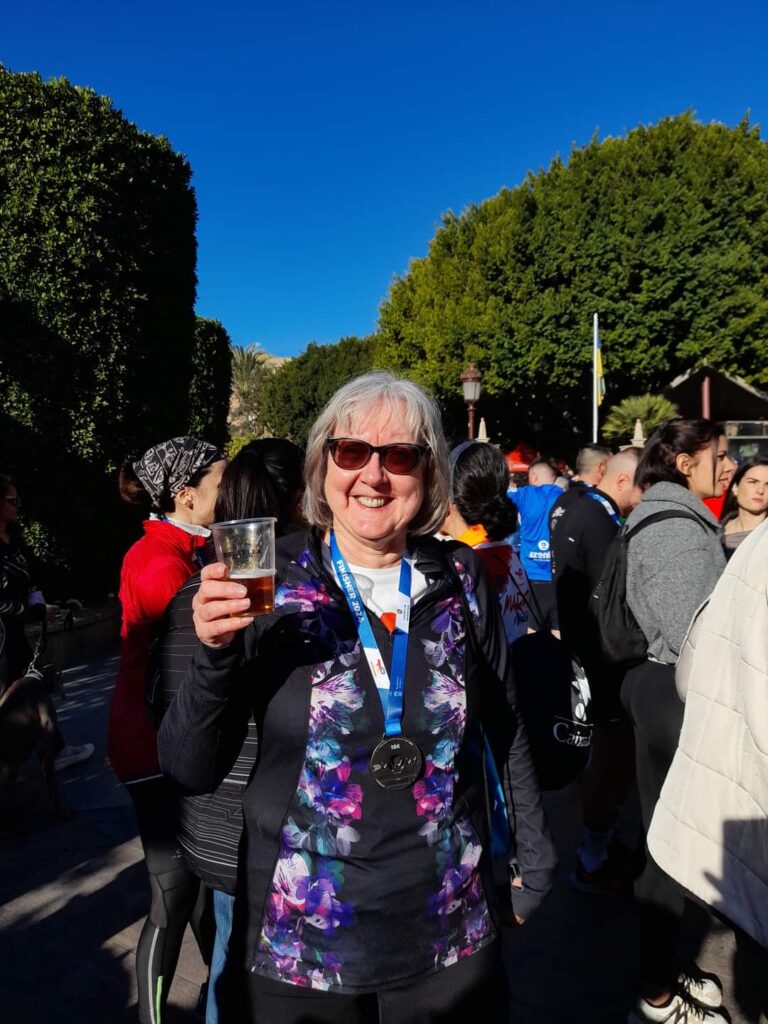 A woman holding a glass of beer