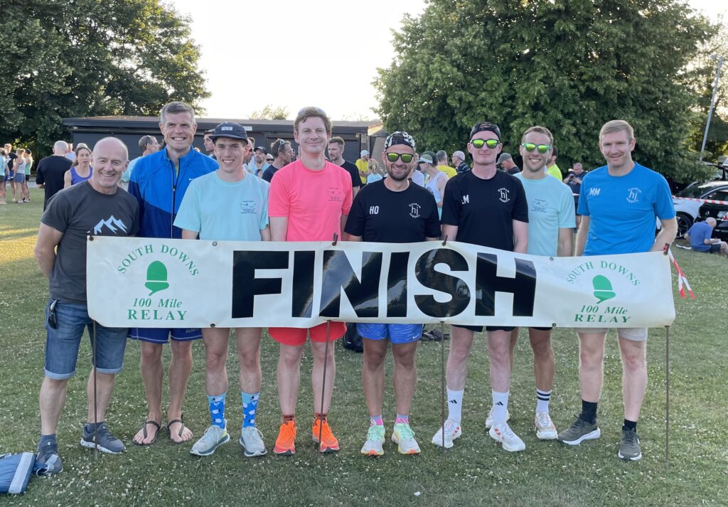 A group of runners with a Finish sign
