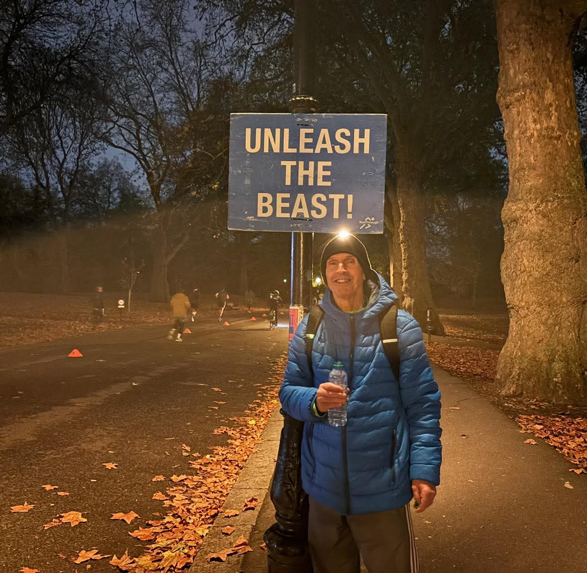 Chris Wigby in front of a sign saying Unleash the Beast