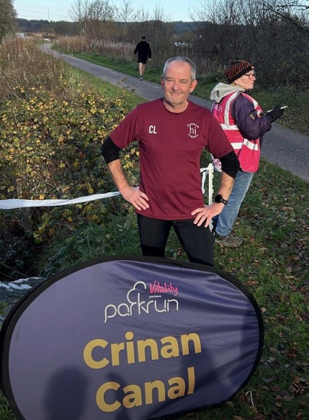Carl Laver behind a parkrun sign