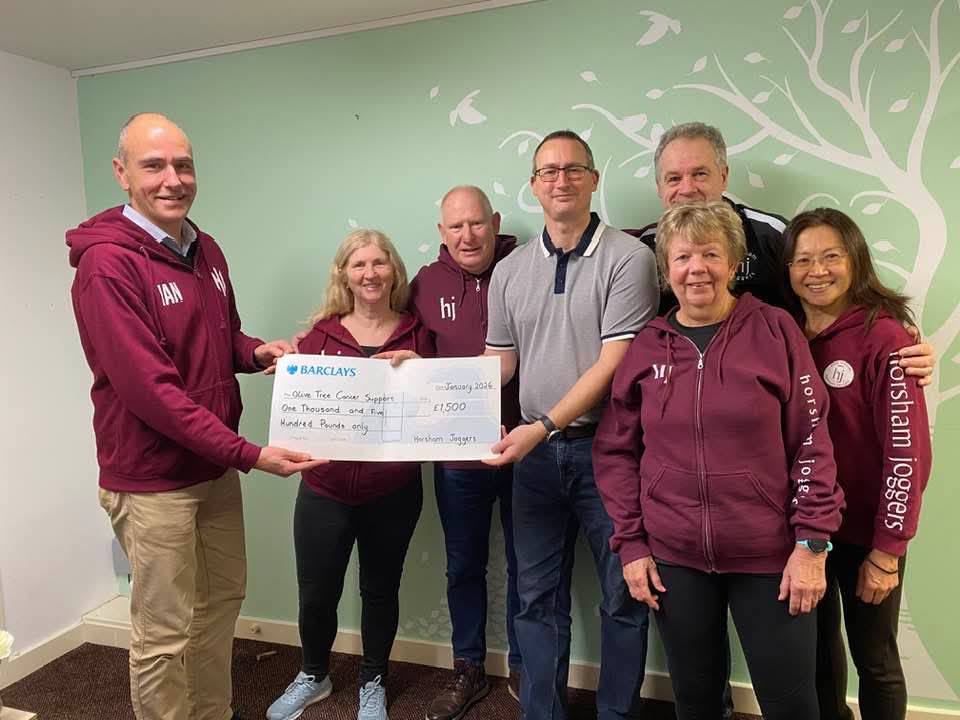 A group pf people with a large-sized cheque