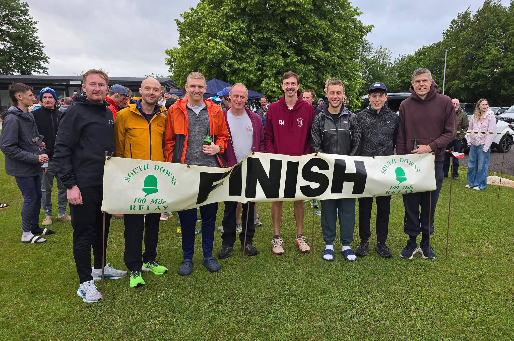 A group of runners holding a Finish banner