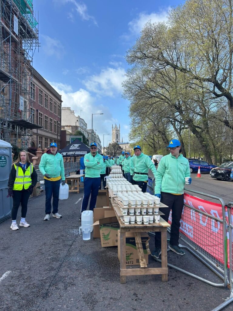 A group of Horsham Joggers wearing volunteer kit at Brighton Marathon