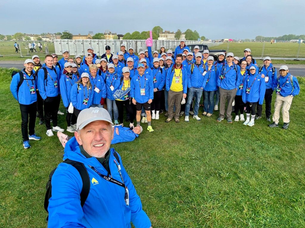 A group of Horsham Joggers wearing volunteer kit at London Marathon